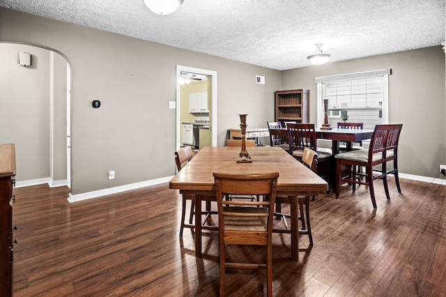 dining area featuring dark hardwood / wood-style flooring and a textured ceiling