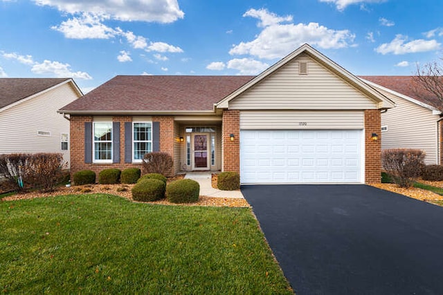 ranch-style home featuring a garage and a front yard