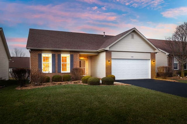 ranch-style home with a lawn and a garage