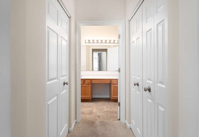 hallway featuring light carpet