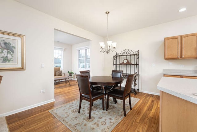 dining room featuring dark hardwood / wood-style flooring and a chandelier