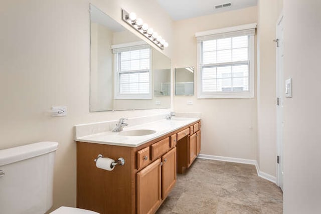 bathroom featuring toilet and vanity