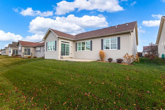 back of property featuring a patio area and a lawn