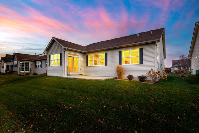 view of front of property with a yard and a patio