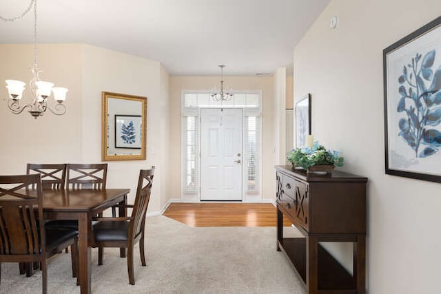 foyer entrance with carpet and a chandelier