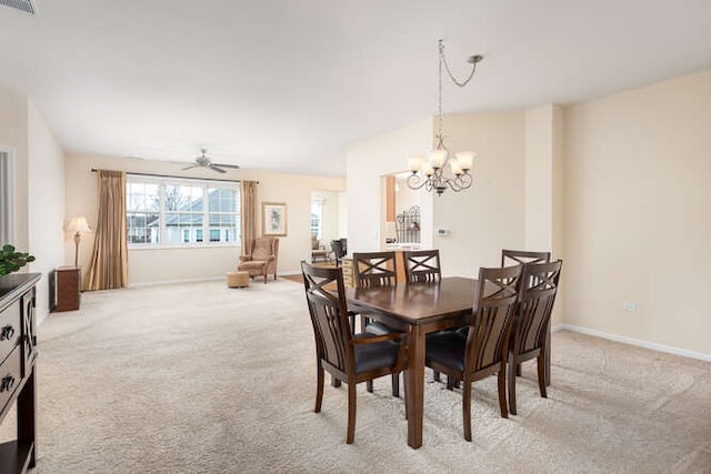 carpeted dining room featuring ceiling fan with notable chandelier