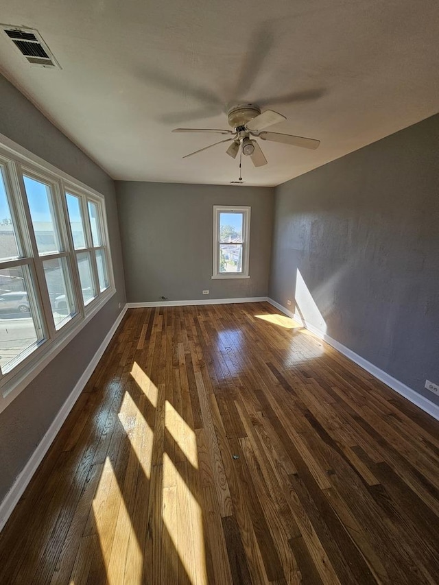 unfurnished room featuring ceiling fan and dark hardwood / wood-style flooring