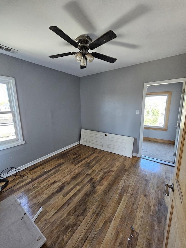 unfurnished room featuring dark hardwood / wood-style floors and ceiling fan