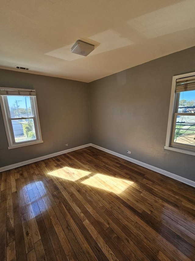 spare room featuring dark wood-type flooring