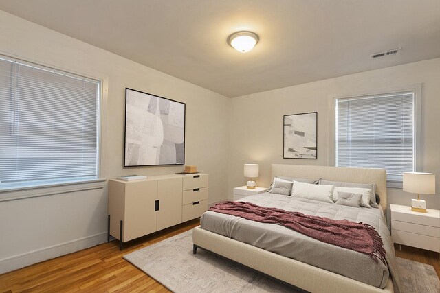 living room with light wood-type flooring and plenty of natural light