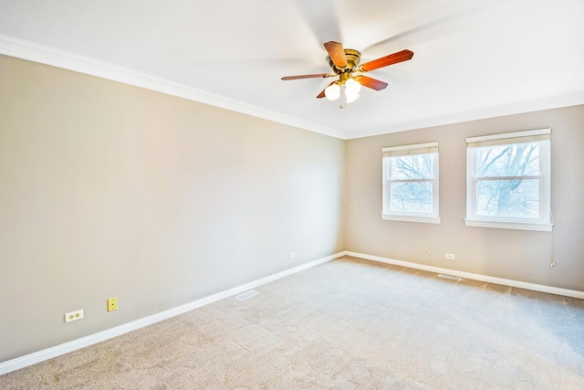 unfurnished room with crown molding, carpet, and ceiling fan