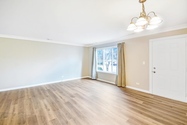 unfurnished room with an inviting chandelier, ornamental molding, and light hardwood / wood-style flooring