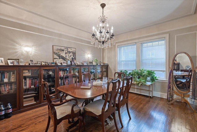 dining room featuring a notable chandelier, dark hardwood / wood-style floors, and ornamental molding