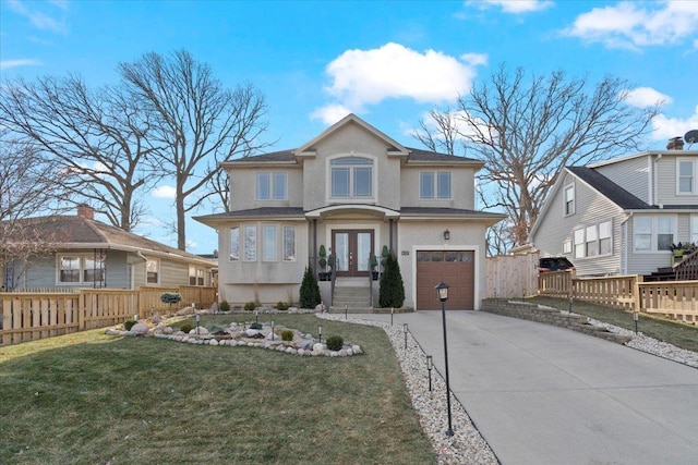 view of front of home featuring a front yard, french doors, and a garage