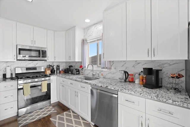 kitchen featuring sink, white cabinets, and appliances with stainless steel finishes