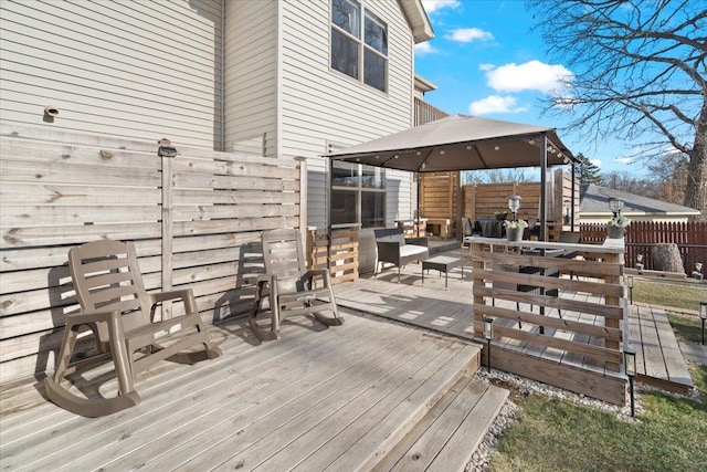 wooden terrace featuring a gazebo