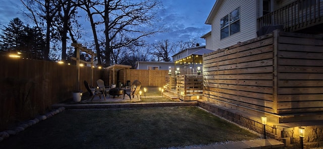 yard at dusk with a fire pit and a patio area