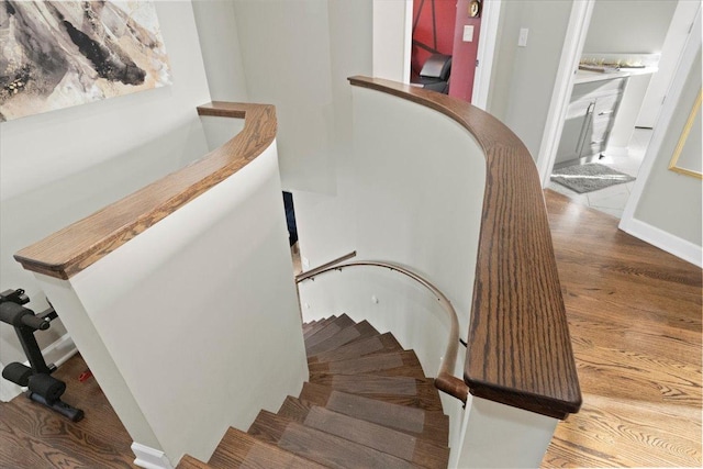 stairs featuring wood-type flooring