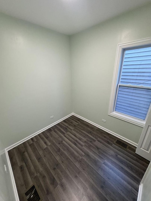 spare room with dark hardwood / wood-style floors