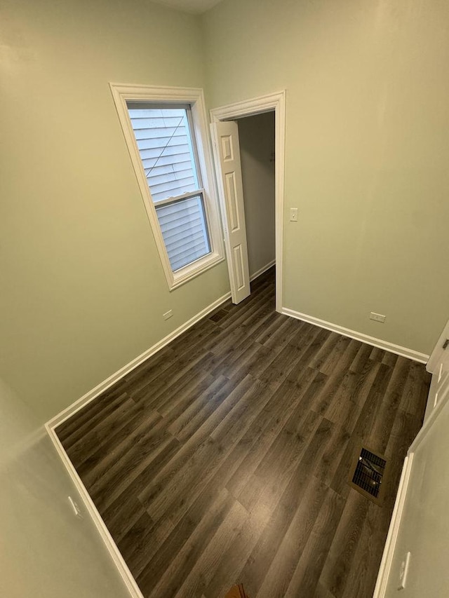 empty room featuring dark wood-type flooring