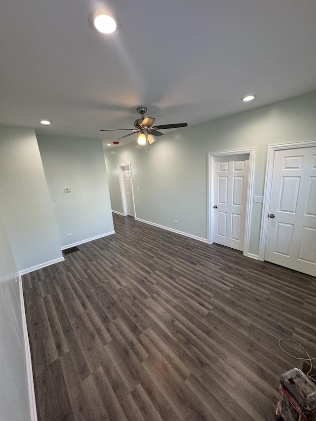 interior space featuring ceiling fan and dark hardwood / wood-style flooring