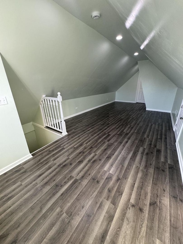 bonus room featuring dark hardwood / wood-style floors and vaulted ceiling