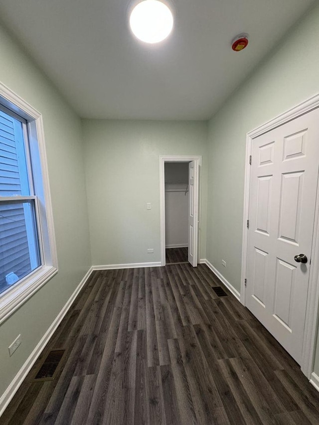 unfurnished bedroom featuring dark hardwood / wood-style flooring