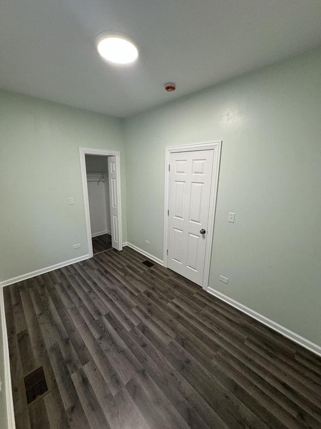 unfurnished bedroom with dark hardwood / wood-style floors