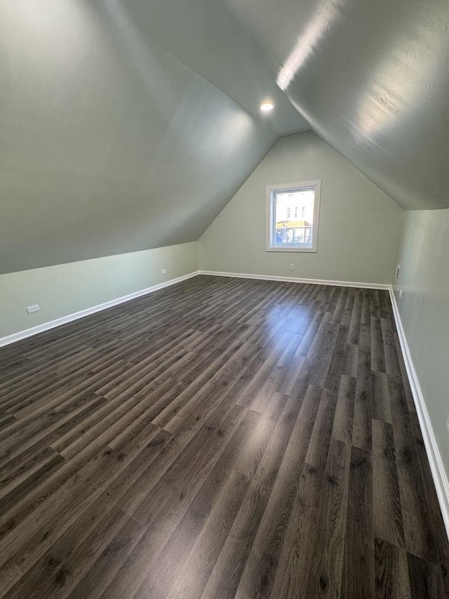 bonus room featuring dark hardwood / wood-style floors and vaulted ceiling