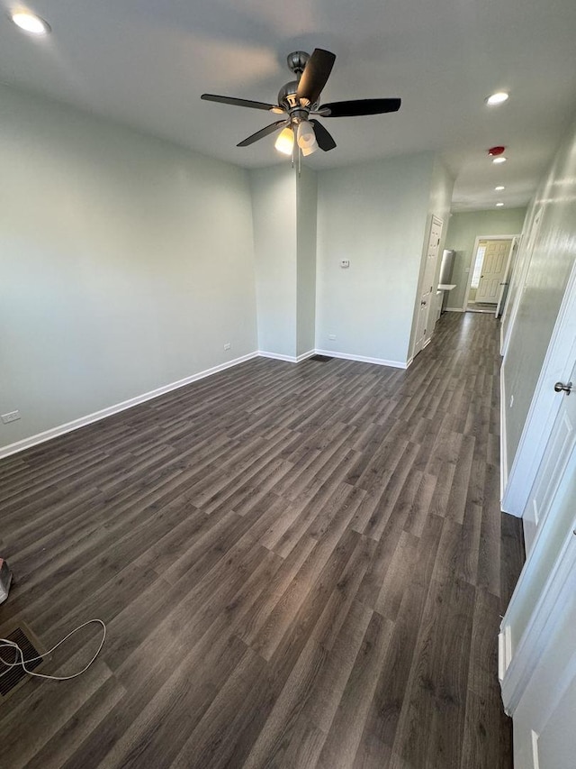 unfurnished living room with dark hardwood / wood-style floors and ceiling fan