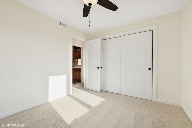 unfurnished bedroom featuring a closet, ceiling fan, and light colored carpet