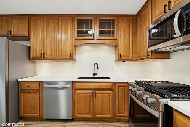 kitchen featuring sink, stainless steel appliances, and light hardwood / wood-style floors