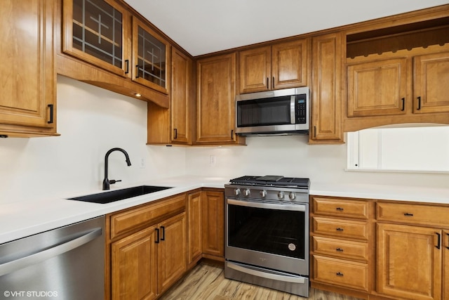 kitchen featuring light hardwood / wood-style floors, sink, and appliances with stainless steel finishes