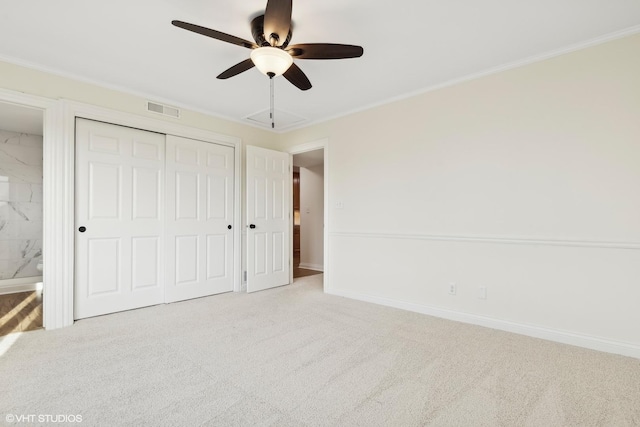 unfurnished bedroom with light carpet, a closet, ceiling fan, and crown molding