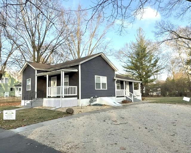 view of front of property with covered porch and a front lawn