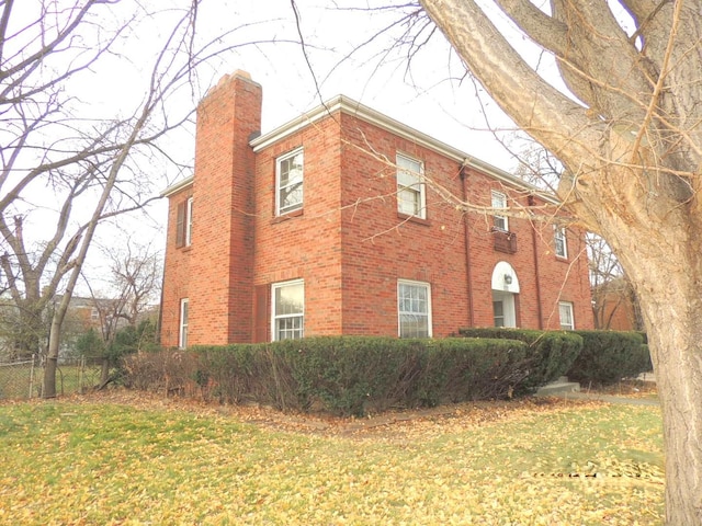 view of side of property with a lawn