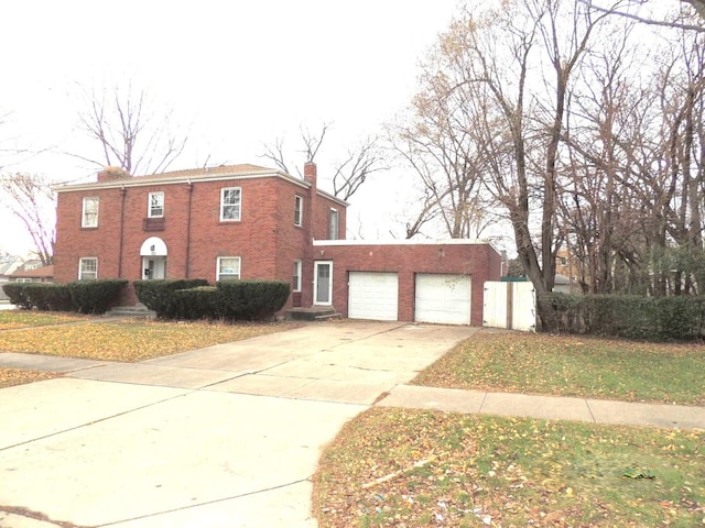 view of front of home with a garage and a front lawn