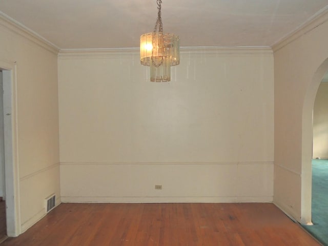 unfurnished room with a chandelier, hardwood / wood-style flooring, and ornamental molding