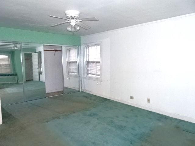 unfurnished bedroom featuring carpet flooring, ceiling fan, and a closet