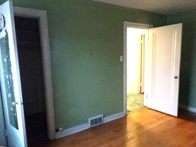 unfurnished bedroom featuring wood-type flooring