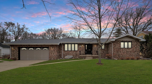 view of front of home with a lawn and a garage