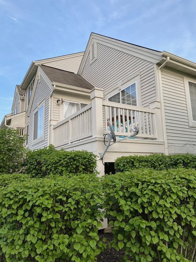 back of house featuring a balcony