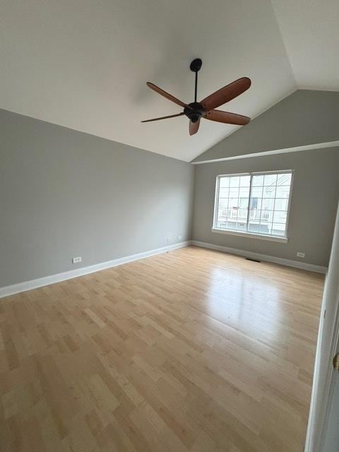 empty room featuring light wood-type flooring, vaulted ceiling, and ceiling fan