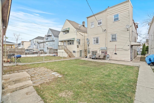 back of property with a patio and a lawn