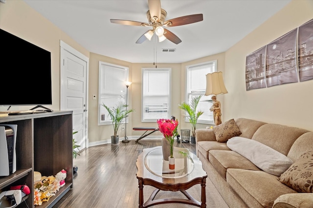 living room featuring dark hardwood / wood-style flooring and ceiling fan