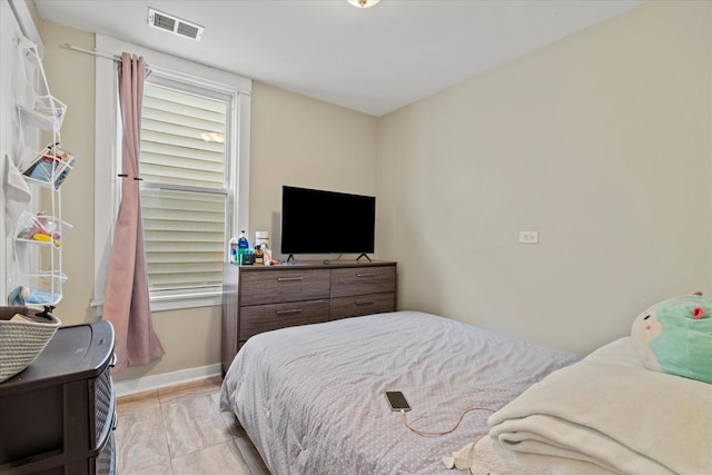 bedroom with light tile patterned floors