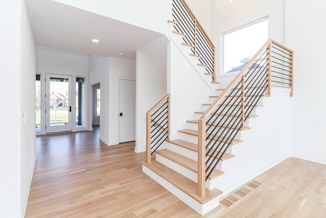 stairs with hardwood / wood-style floors