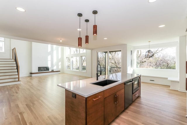 kitchen featuring a wealth of natural light, sink, and light wood-type flooring