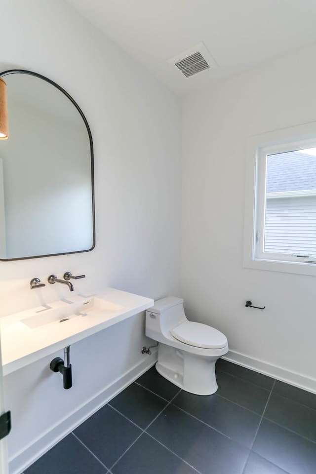 bathroom with tile patterned flooring and toilet