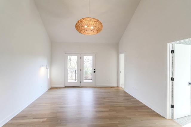 foyer featuring high vaulted ceiling and light hardwood / wood-style flooring